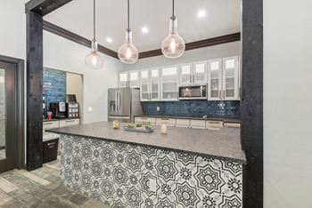 A kitchen with a black and white patterned island.